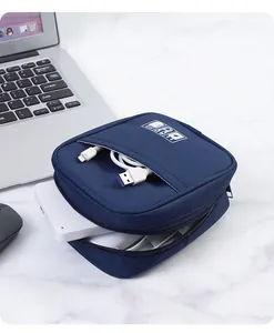 Detail view of navy blue travel cable organizer bag with USB cables and power bank inside