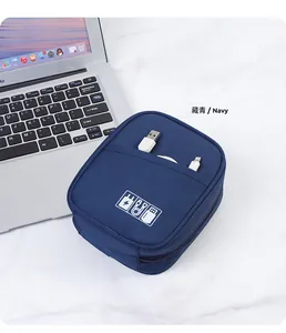 Navy portable digital organizer bag for cables and chargers on marble surface