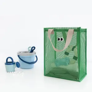 Cute green mesh beach bag with googly eyes for summer travel storage and beach toys