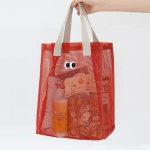 Red mesh tote bag with cute cartoon eye design for summer beach or travel use