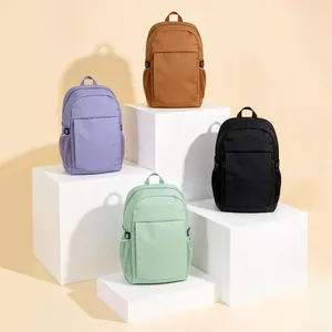 Group display of colorful large capacity outdoor travel backpacks on white geometric pedestals
