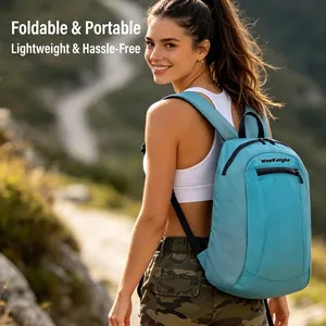 Lightweight blue foldable hiking backpack for outdoor travel, worn by a female model on trail