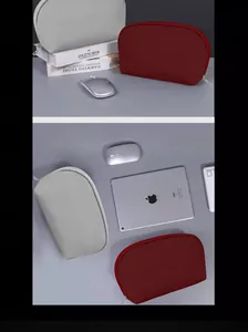 Detailed view of grey and burgundy digital accessory pouches paired with tech gadgets