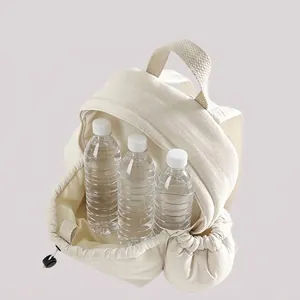 Minimalist white travel backpack showing expanded capacity with water bottles