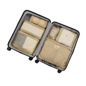 Premium 6-piece beige travel packing cubes set neatly organized inside an open black suitcase
