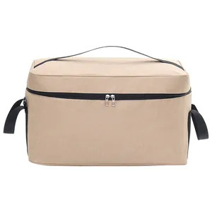 Große isolierte Picknick-Kühltasche aus beigem Stoff mit praktischen schwarzen Griffen