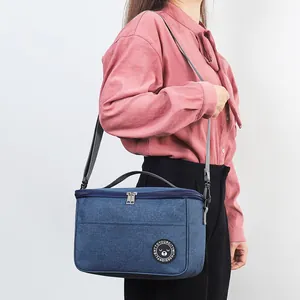 Blue portable insulated lunch bag with adjustable shoulder strap for outdoor use