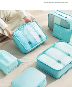 Arrangement of light blue travel packing cubes in various sizes for organized luggage