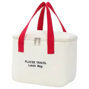 Cream canvas insulated lunch bag with red handles and PLAYER TRAVEL printed logo