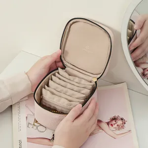 Portable pink leather jewelry organizer box with internal storage pouches