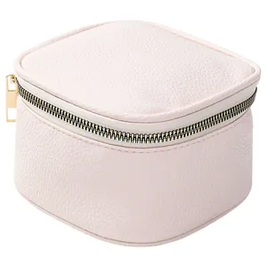 Portable light pink pebbled leather jewelry storage box with gold zipper closure