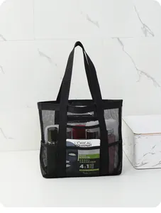 Large black mesh shower caddy tote bag showing capacity with various toiletries inside