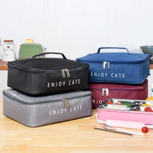 Stack of rectangular insulated lunch bags in multiple colors for office bento box