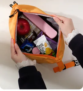Detailed view of the large capacity interior of the orange insulated lunch bag