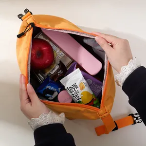 Large capacity orange insulated lunch bag shown with snacks and bento box inside