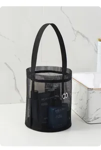 Close-up of black mesh bucket bag with cute eye design for beach or bath storage