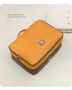 Detailed view of a large travel storage bag for clothes and quilts in yellow and brown