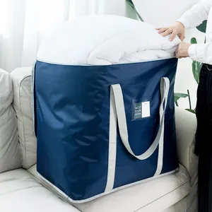 Large navy blue non-woven storage bag for quilts and bedding, shown on a light sofa