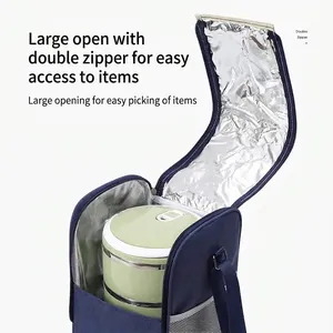 Insulated blue thermal lunch bag with a large opening and shoulder strap for picnic