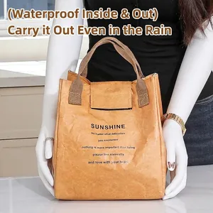 Minimalist DuPont paper insulated lunch bag held by a model in a modern kitchen setting