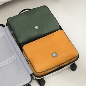 Set of two large portable travel packing cubes in olive green and mustard yellow color