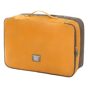 Large capacity orange and brown travel storage bag for organizing clothes and quilts.