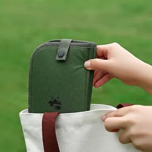 Portable folding green seat cushion for outdoor camping, hiking and picnic use on natural grass