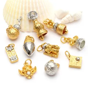Collection of ancient gold Buddhist charms with mantra engravings and bell pendants