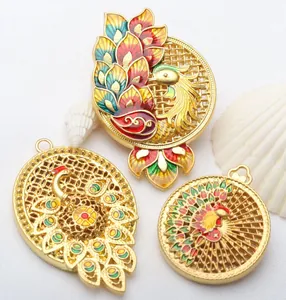 Close-up view of vintage gold hollow peacock pendants featuring colorful enamel details