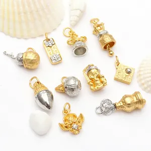 Detailed macro view of various intricate two-tone Buddhist mantra charms and Dharma pendants.