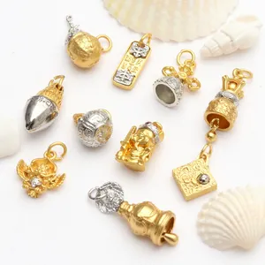 Detailed macro shot of assorted gold and silver Buddhist-style DIY charms with shells