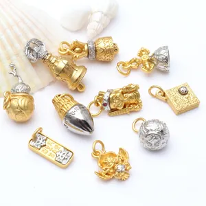 Close-up of ancient gold and silver Buddhist mantra pendants for DIY jewelry