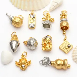 Detailed view of antique gold Buddhist charms with Six-Syllable Mantra and bells