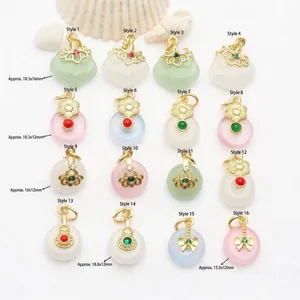 Detail view of 16 ancient gold style pendants with varied jade-like designs and sizes.