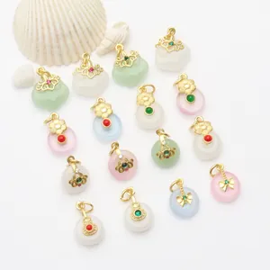 Detailed macro view of assorted ancient gold style pendants featuring colorful jade-like donuts