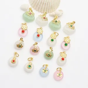 Close-up of ancient-style gold pendants with colorful jade-like stones for DIY jewelry charms