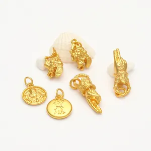 Detailed view of various gold-plated sand gold pendants with traditional Buddha hand motifs