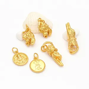 Detailed view of ancient gold-style Buddha hand and round coin charms for DIY jewelry crafting