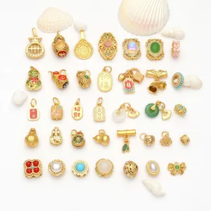 Detail view of various Chinese style gold-plated lucky charms for DIY jewelry making