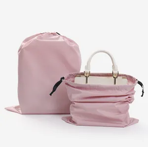 Pink waterproof drawstring storage bag showing usage with a handbag inside
