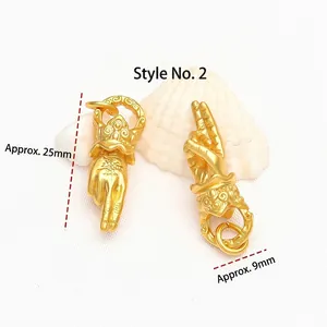 Detailed view of ancient gold-plated Buddha hand mudra pendants for DIY jewelry necklace making