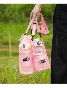 Pink mesh water bottle carrier bag with adjustable crossbody shoulder strap for outdoor hiking.