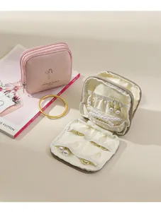Detail of pink portable jewelry pouch with multiple compartments for rings and necklaces