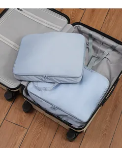 Detail view of light blue travel packing cubes for clothes organizer in a suitcase
