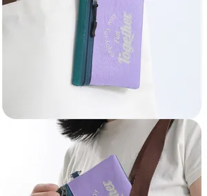 Close-up detail of the purple anti-theft travel passport pouch worn with a strap
