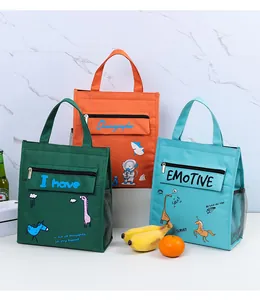 Set of three colorful insulated lunch bags with cartoon prints displayed with fresh fruits