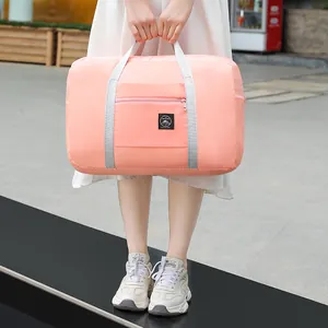Portable pink large capacity travel duffel bag with front zipper pocket for short trips