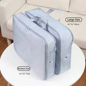 Set of two light blue travel compression organizers in medium and large sizes for luggage