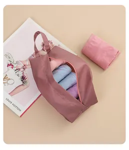 Detail view of a pink portable travel underwear storage bag with handle