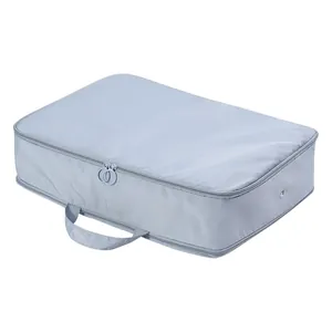 Large capacity portable travel clothes storage bag in light blue grey with handle